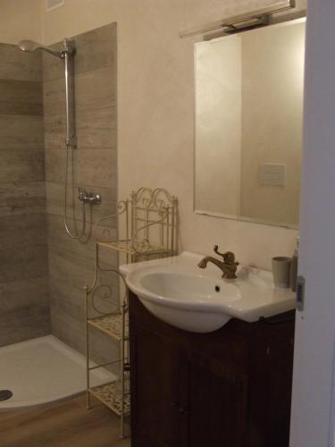 a bathroom with a sink and a shower with a mirror at B&B Solstizio d'estate in San Felice del Benaco