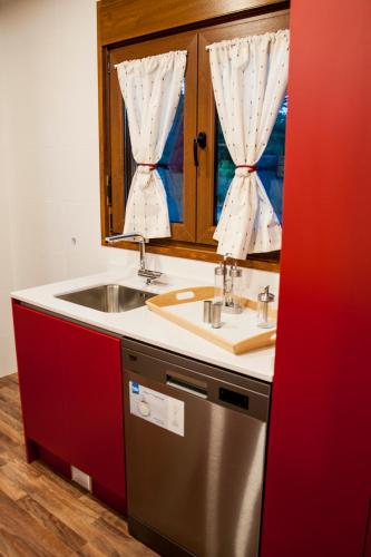 a kitchen with a sink and a window at El Rincón de Guica in Teruel