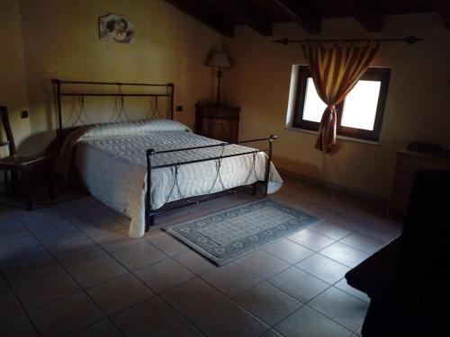 a bedroom with a bed and a window at Agriturismo La Valle Incantata Gerace - in Gerace