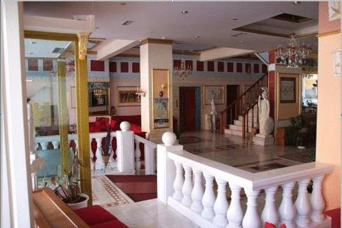 a lobby of a building with a staircase and a room at Hotel Kosta Famissi in Kalabaka