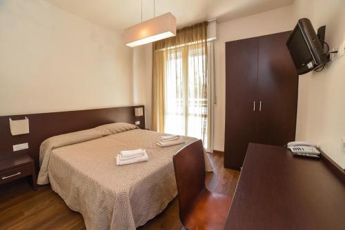 sypialnia z łóżkiem z dwoma ręcznikami w obiekcie HOTEL DIAMANTE w Cesenatico