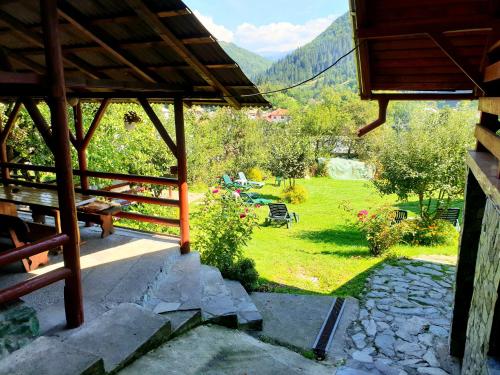 a view from the porch of a house with a garden at Vila Giulia Voineasa in Voineasa