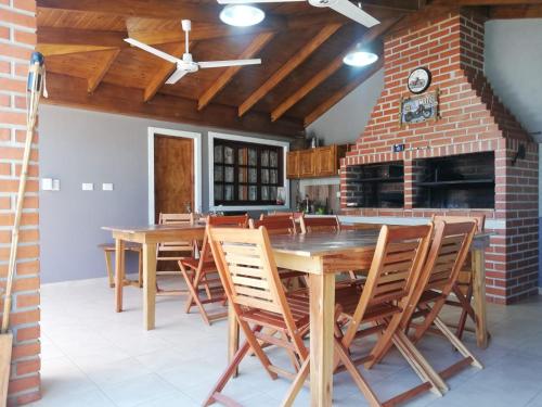 a dining room with a wooden table and chairs at Apart portal de la selva in Puerto Iguazú
