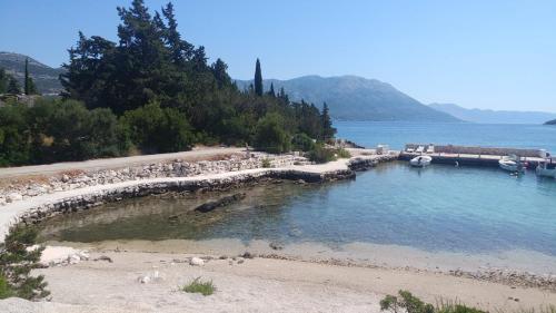 a beach with boats in a body of water at Apartment Stanisic in Korčula