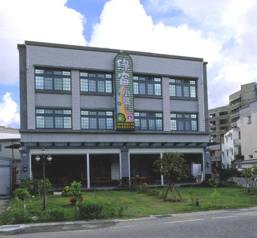 a building with a sign on the front of it at Green Window Homestay in Hualien City