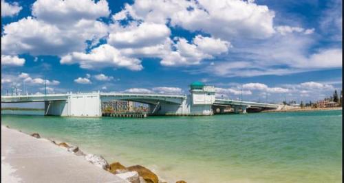 a bridge over a body of water next to a beach at John's Pass Hotel - Fully Remote Check In in St Pete Beach