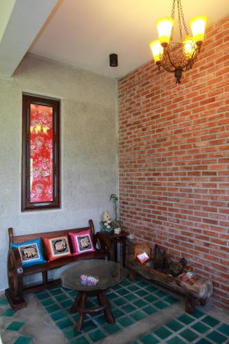 a living room with a brick wall and a couch at Mandheling B&B in Jian