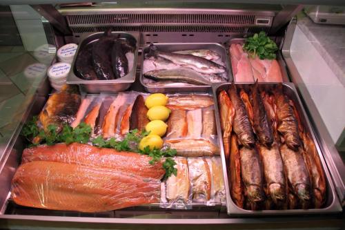 a refrigerator filled with lots of different types of seafood at Forellenhof in Siegsdorf