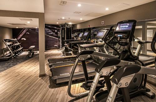 a gym with several treadmills and elliptical machines at Hotel Indigo - Birmingham Five Points S - UAB by IHG in Birmingham
