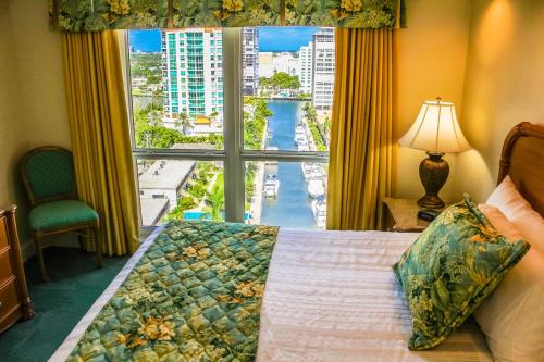 a bedroom with a bed and a large window at Ft. Lauderdale Beach, a VRI resort in Fort Lauderdale