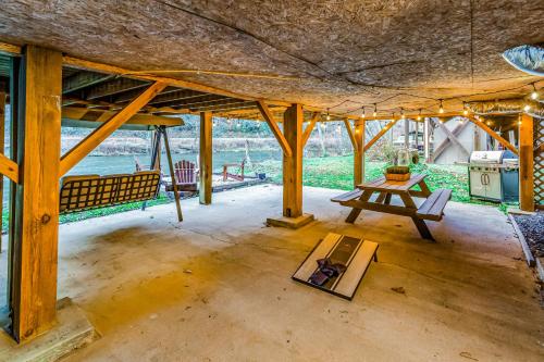 a room with a table and a picnic table at North River Views in Sylva