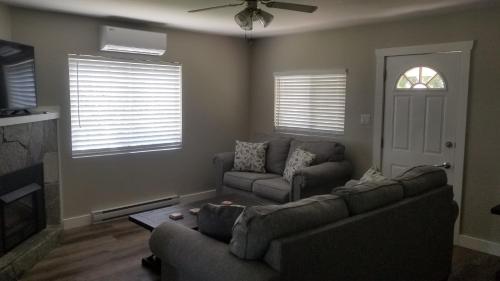 a living room with two couches and a fireplace at Sandy Beach Suites in Osoyoos