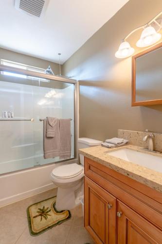 a bathroom with a toilet and a shower and a sink at Sunlight Retreat in Twentynine Palms