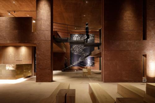 a lobby with a spiral staircase in a building at GALLERIA MIDOBARU in Beppu