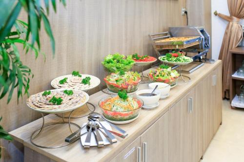 een buffet lijn met kommen eten erop bij Mai Thang Hotel Da Lat in Da Lat