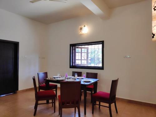 a dining room with a table and chairs at Beach Villa Morjim in Morjim