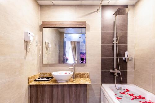 a bathroom with a sink and a bath tub at Mai Thang Hotel Da Lat in Da Lat