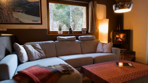 a living room with a couch and a table at Pont de Valenti Mountain Retreat in Girona