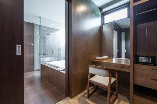 a bathroom with a desk and a sink and a shower at Movenpick Luxury Villa1FL-Private Pool-SHA CERTIFIED in Na Jomtien