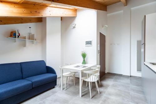 a living room with a blue couch and a table at Dreams Hotel Residenza Pianell 10 in Milan