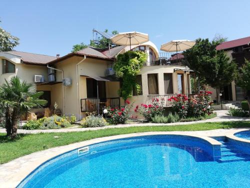 a house with a swimming pool in front of a house at Complex Maxim in Varna City