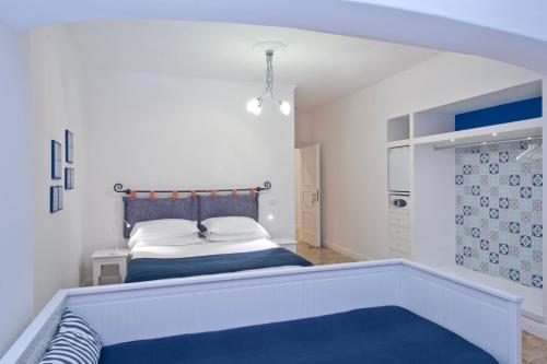 a bedroom with a bed with a blue bed frame at Casa Stella Marina in Praiano