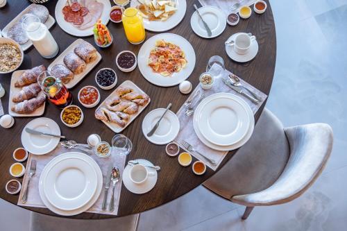 a table with plates of breakfast food on it at Villa Mosavali in Akhalubani