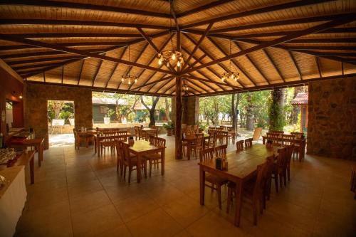 an empty restaurant with wooden tables and chairs at Eden Bungalows and Beach in Koycegiz