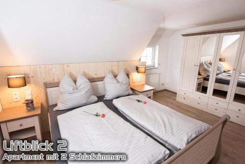 a bedroom with two beds and a mirror at Ferienwohnungen "Liftblick 2 oder 3" im Kurort Altenberg in Kurort Altenberg