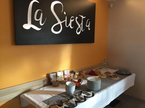 a table with plates and shoes on top of it at B&B La Siesta in Markovci