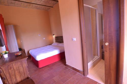 a small bedroom with a bed and a bathroom at Il Casale Di Roma in Prima Porta