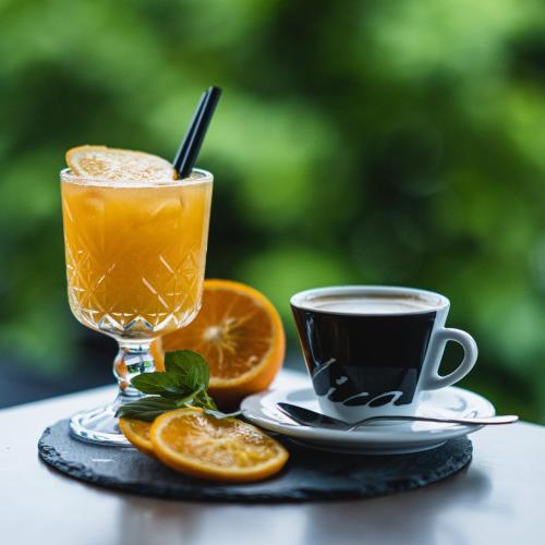 a glass of orange juice and a cup of coffee at B&B La Siesta in Markovci