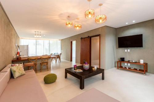 a living room with a couch and a table at Bahay Tatu in Pôrto de Pedras