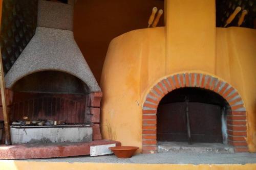 a large brick oven with an open door at beautiful cottage with pool: 8 pers in Isolabona