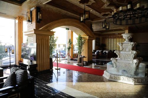 a lobby with a large statue in the middle of a building at Arto Aparthotel in Riyadh