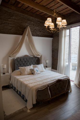 a bedroom with a large bed with a canopy at Versión Moreno B & B in General Villegas