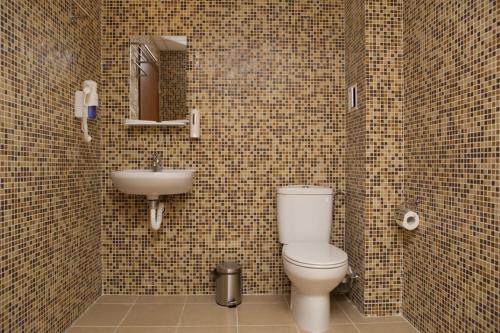 a bathroom with a toilet and a sink at Hotel Motto in Stara Zagora