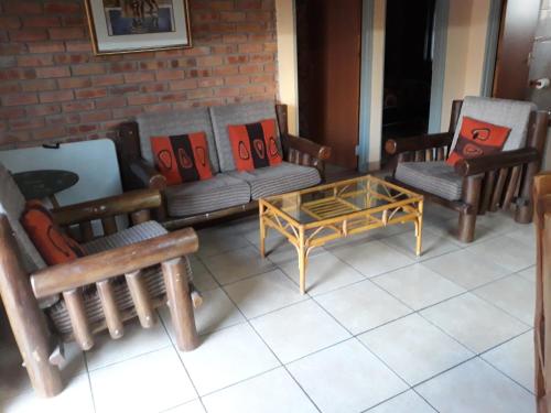 a living room with couches and a coffee table at Eagle's Crest in Marloth Park