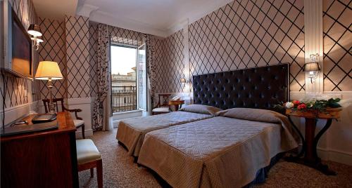 a bedroom with a large bed and a window at Boutique Hotel Trevi in Rome