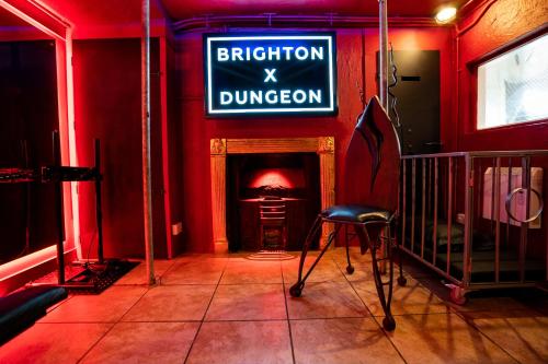 a red room with a sign that reads brighton dungeon at Brighton Erotic Boudoir in Brighton & Hove