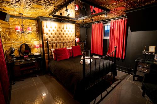 a bedroom with a large bed with red pillows at Brighton Erotic Boudoir in Brighton & Hove
