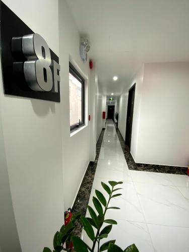 a hallway of a building with a sign on the wall at The Nova Hotel & Apartment in Hai Phong