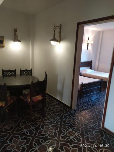 a room with a table and a mirror and a bed at Six Corners Resort in Abū Sulţān