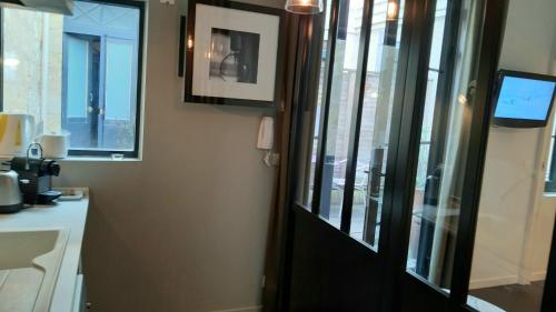 a bathroom with a black door and a window at Burdigala Homes - Les Apparts de la Course in Bordeaux