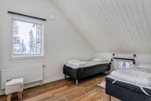 En eller flere senge i et værelse på Ottsjö Bear Lodge