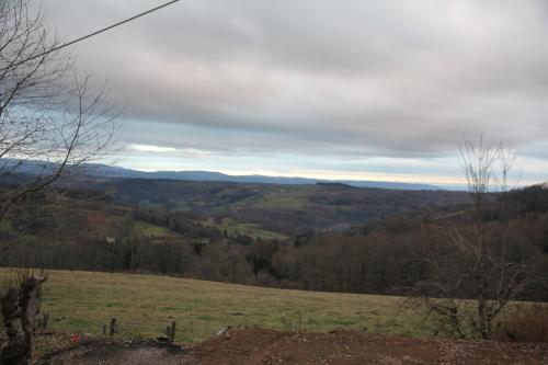 a view of a field with mountains in the distance at Gite Ferme Brelouffe 1 in La Rosière