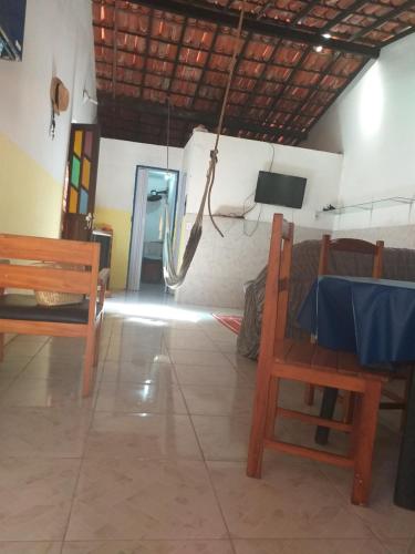 a room with a table and chairs and a television at Casa em Gamboa in Gamboa