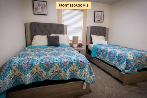 a bedroom with two beds and a sign that reads from bedroom at Downtown - 14 Miles - Cedardale in Houston