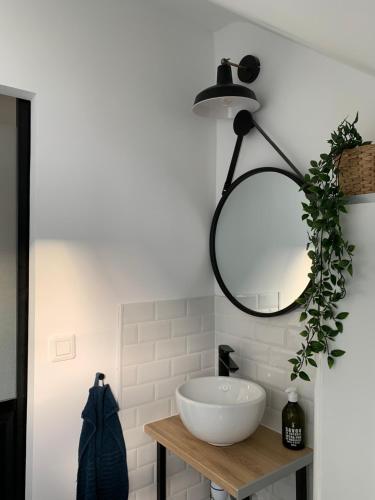 a bathroom with a white sink and a mirror at BLUE MOON in Saint-Nazaire