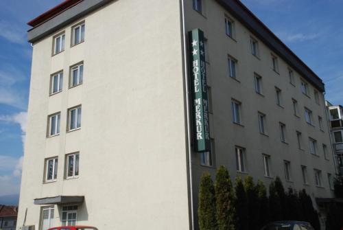 a building with a sign on the side of it at Hotel Merkur in Miercurea-Ciuc
